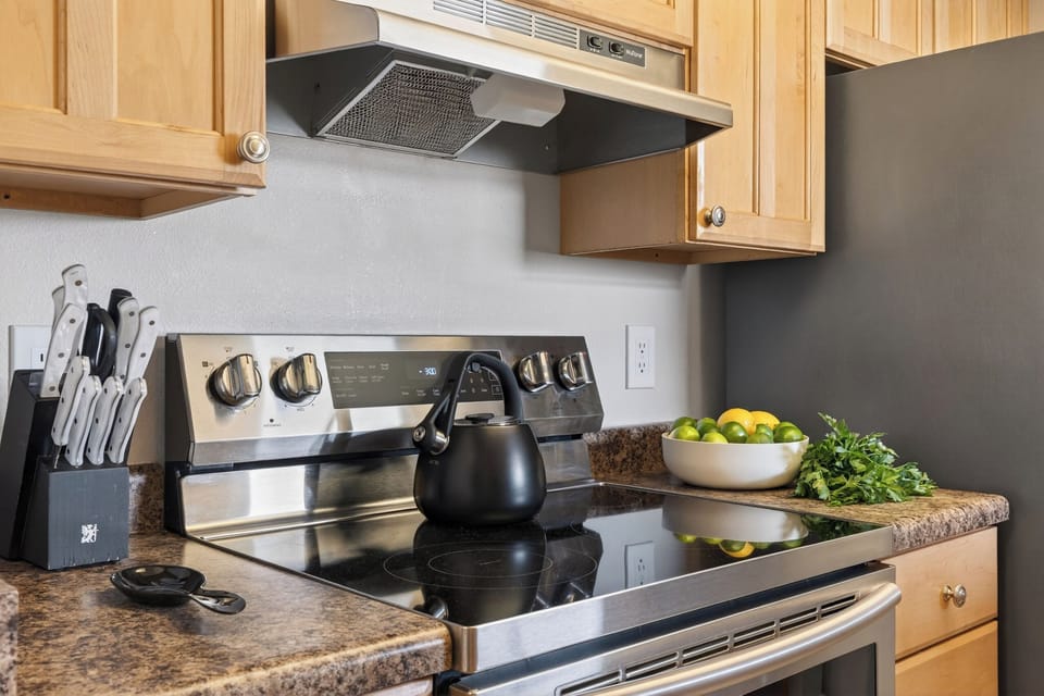 Detail shot of the kitchen stove and countertop items.