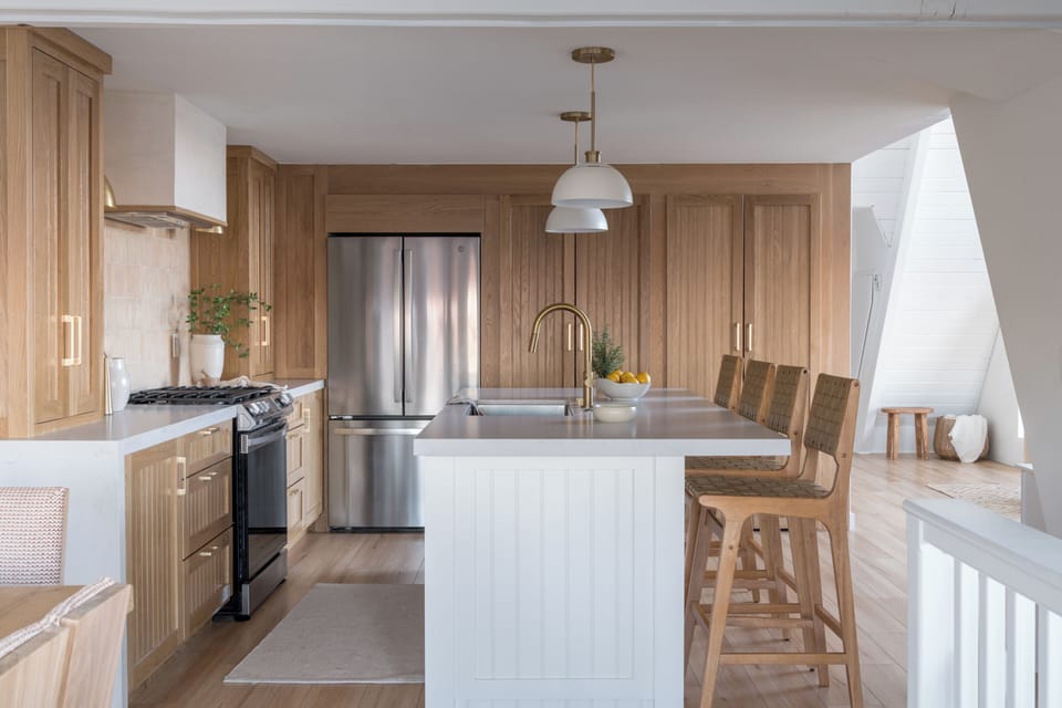 Kitchen island detail showcasing white countertops and wooden cabinetry.