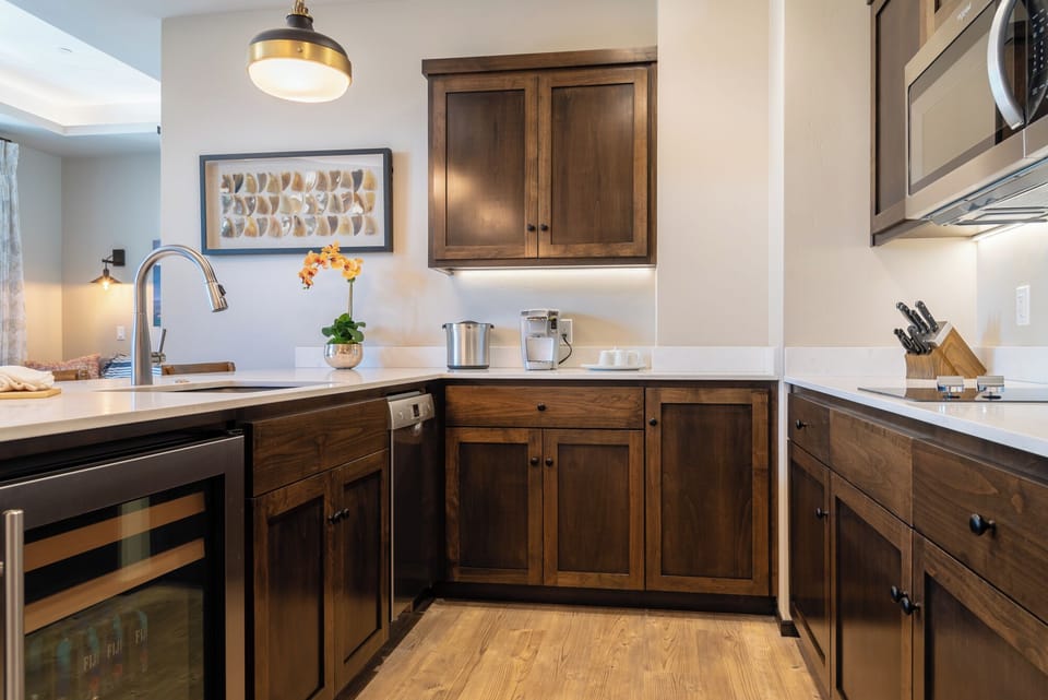 Dark cabinetry and built-ins keep this compact kitchen efficient.
