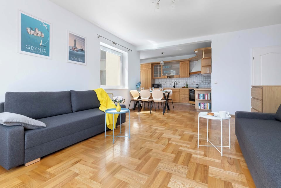 The living area features a sleek coffee table and a flat-screen television.