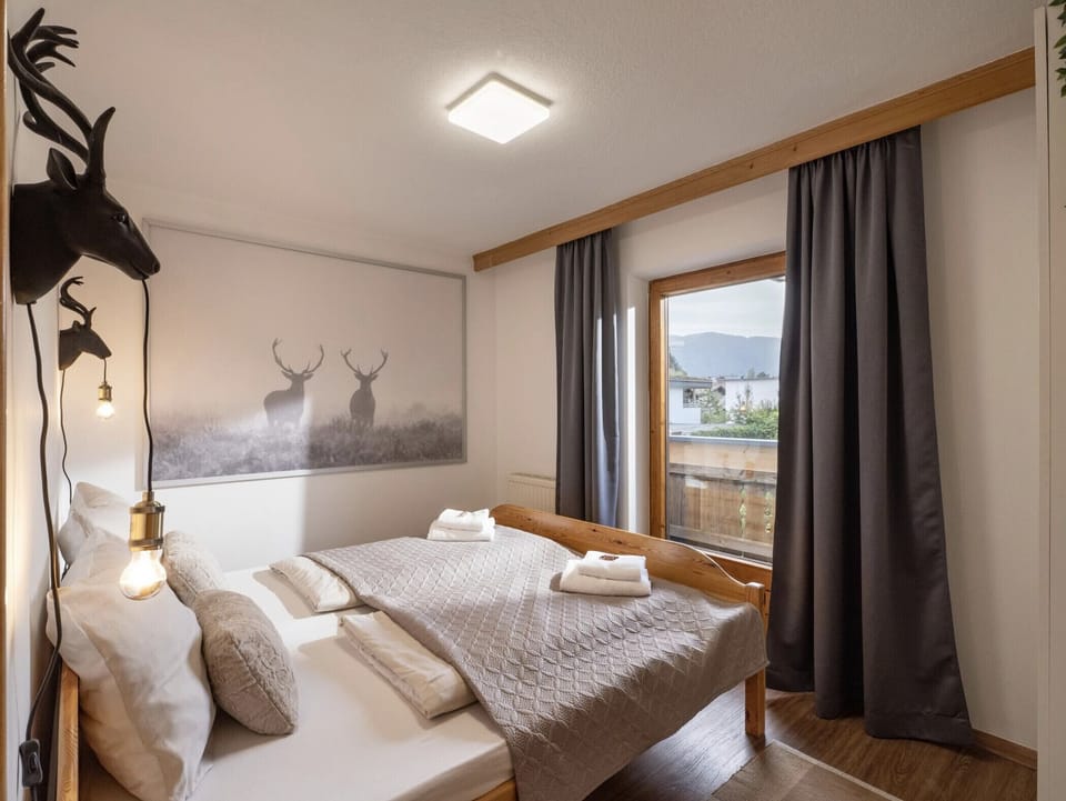 Westendorf vacation apartment with bright bedroom, queen-style bed, balcony access and quiet setting near the village center and ski bus.