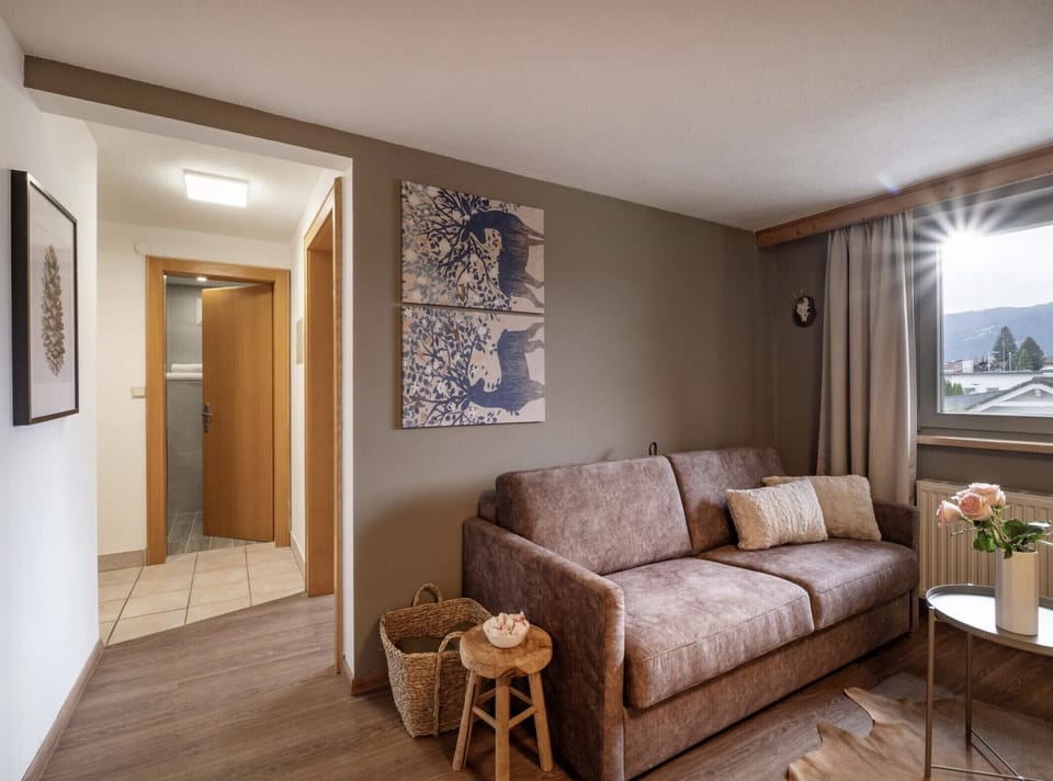 Westendorf vacation apartment with sofa, living space and a quiet neighborhood base for skiing, hiking, biking and exploring the Kitzbühel Alps.