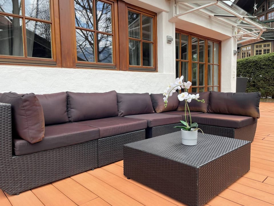 Book a Kitzbühel vacation apartment with large patio, outdoor lounge, quality interiors and location near old town, Streif and ski lift.