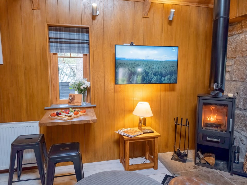 The TV is there if you want it, though the fire usually wins. Lamplight, timber walls and kindling within arm's reach.