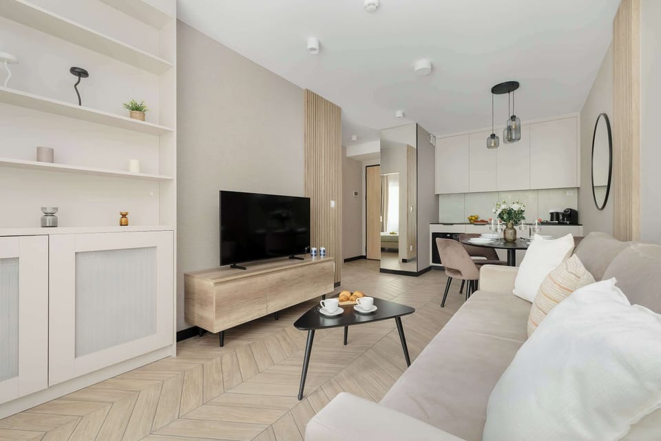 Comfortable living room with sofa, coffee table, TV and built-in storage.