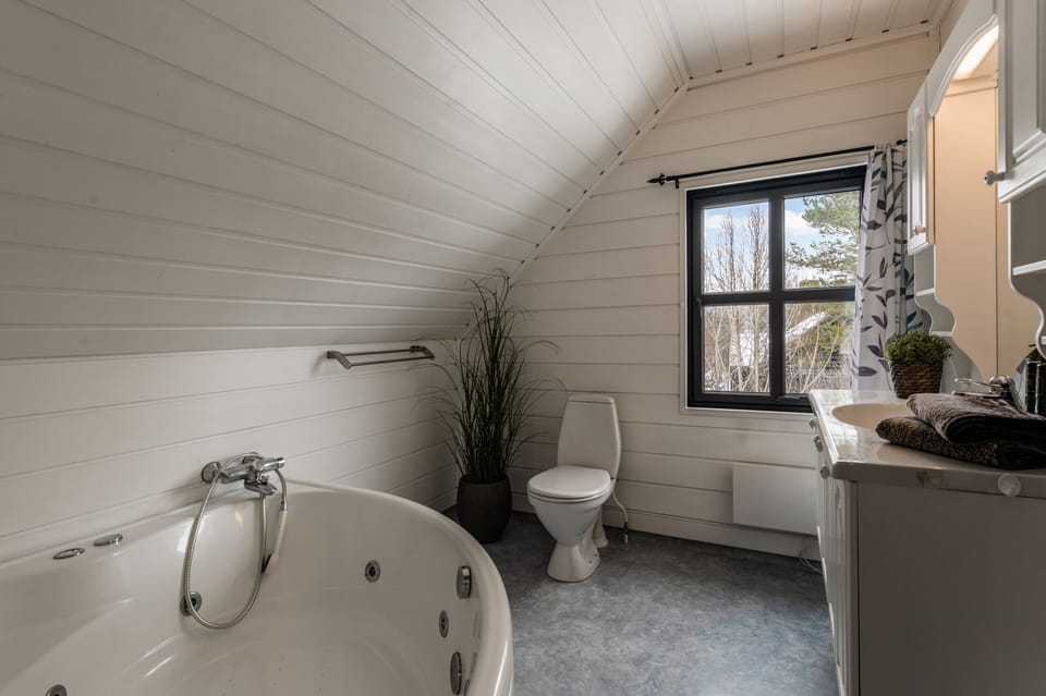 Bathroom with large bathtub with jets