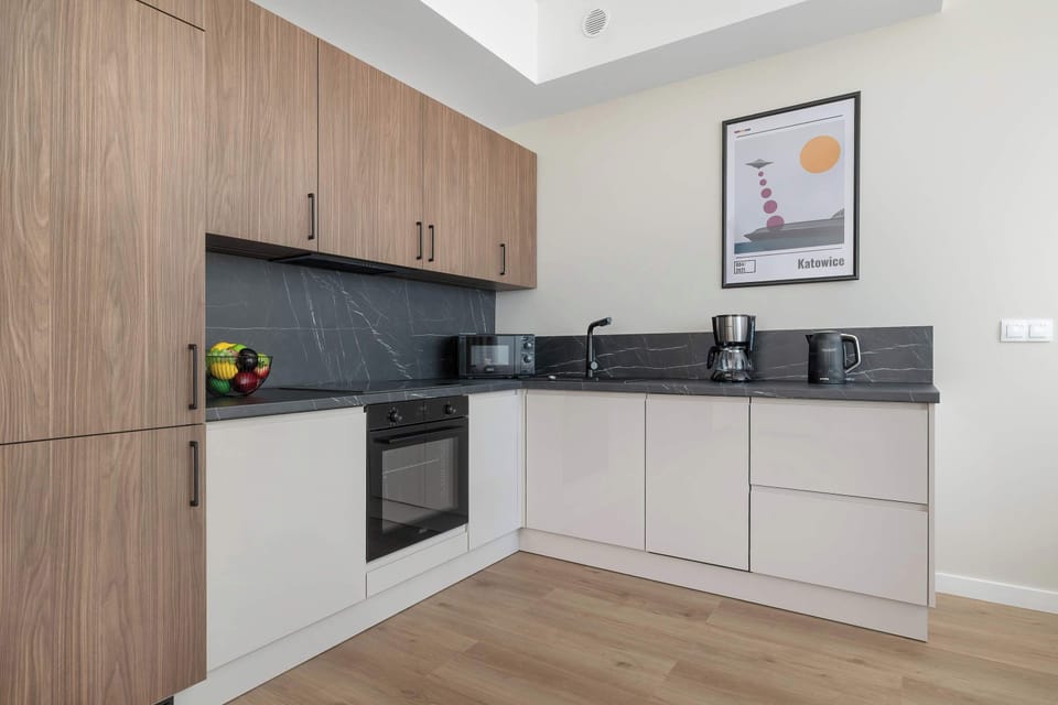 The sleek design of the kitchenette blending seamlessly with the living area.