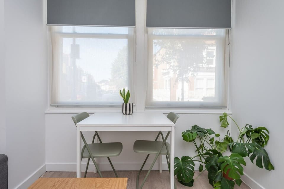 Sunny dining nook with street views and seating for two