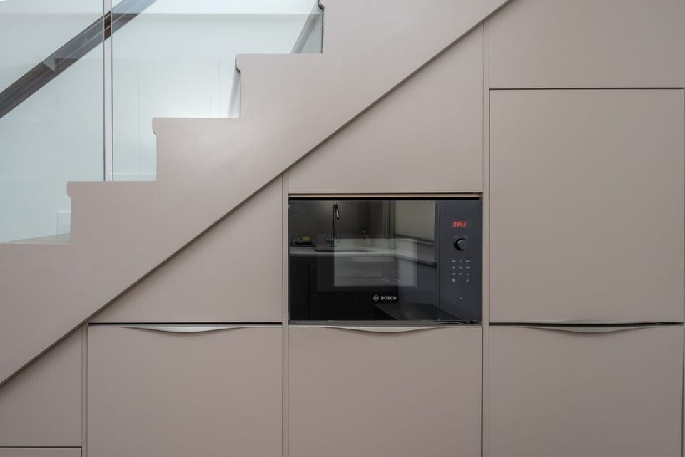 Sleek storage cabinets built into the staircase for extra space
