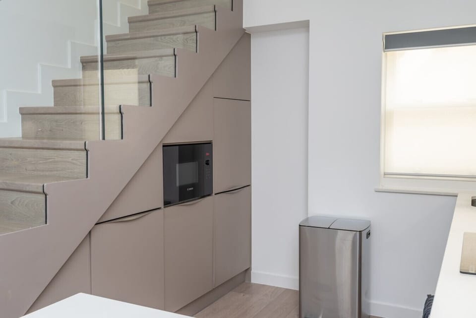 Clever under-stair storage with built-in microwave and appliances