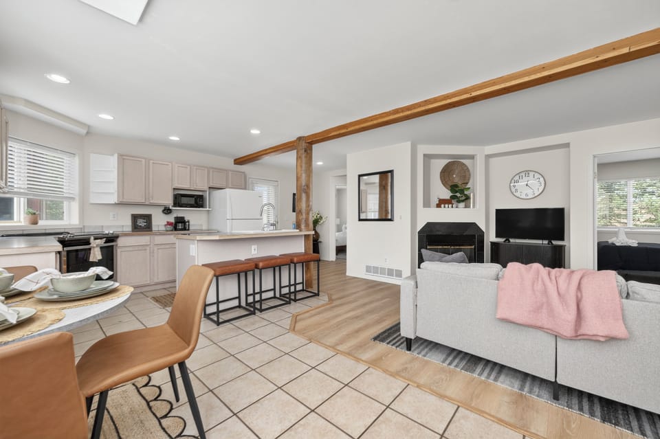 Step into your open-concept haven where kitchen, dining, and living flow together under warm wood beams. Cook, gather, and unwind all in one welcoming space designed for comfort and connection.