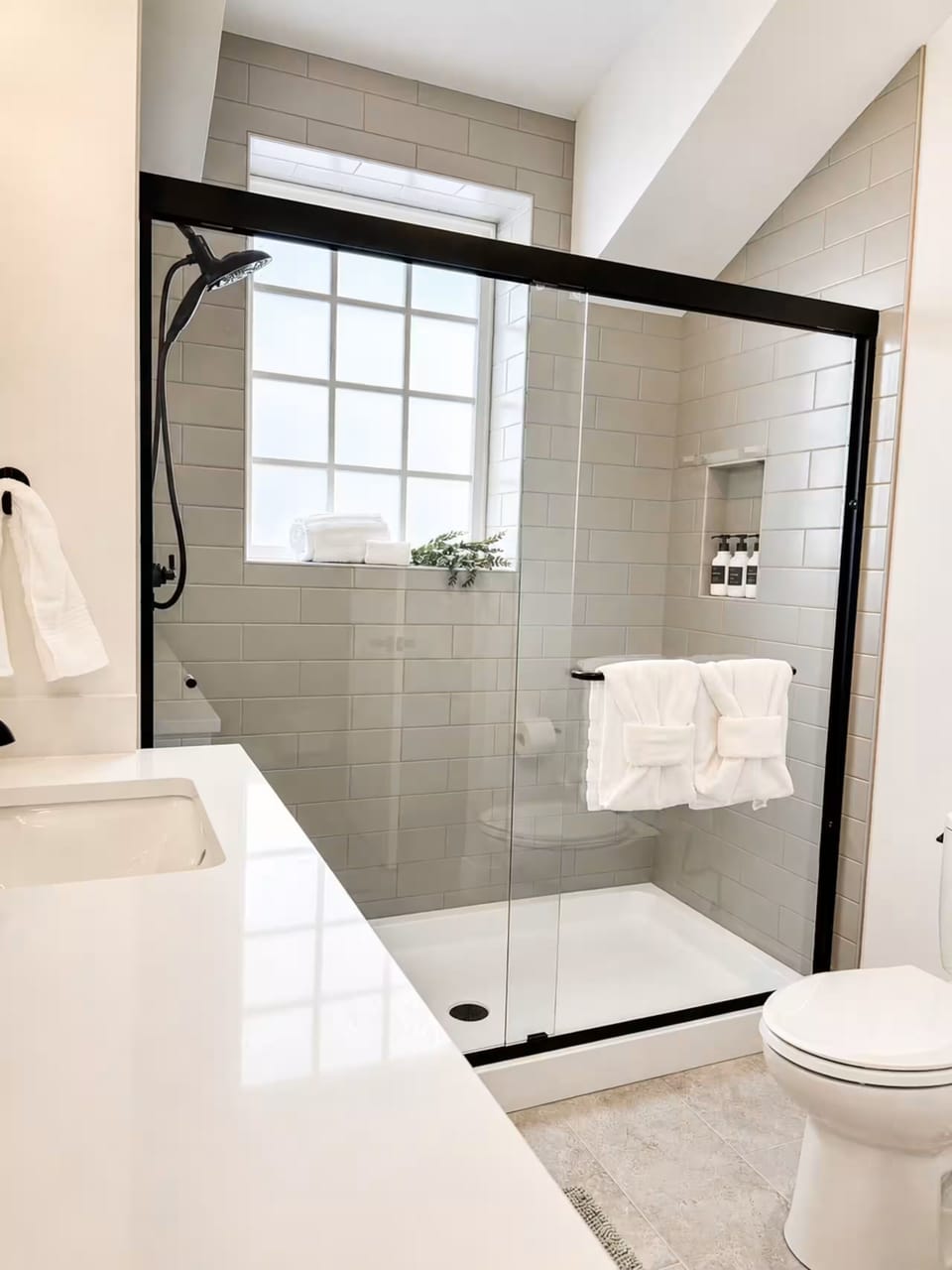 Bright modern bath with walk-in glass shower and natural light