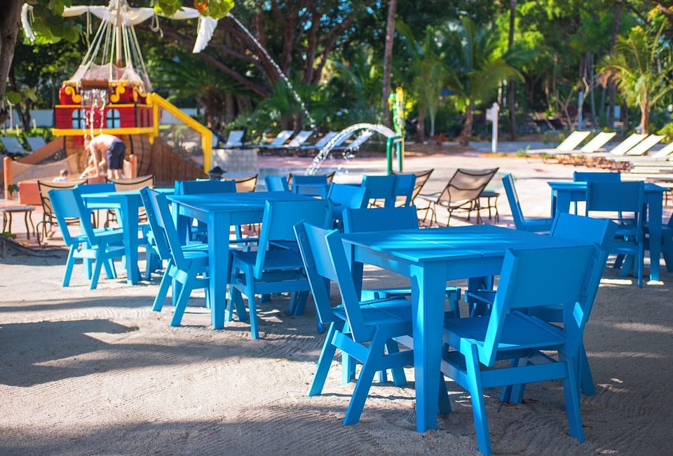 Gather outdoors around bright tables steps from the water fun.