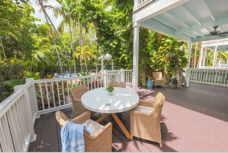 Sip morning coffee on the breezy deck surrounded by greenery.