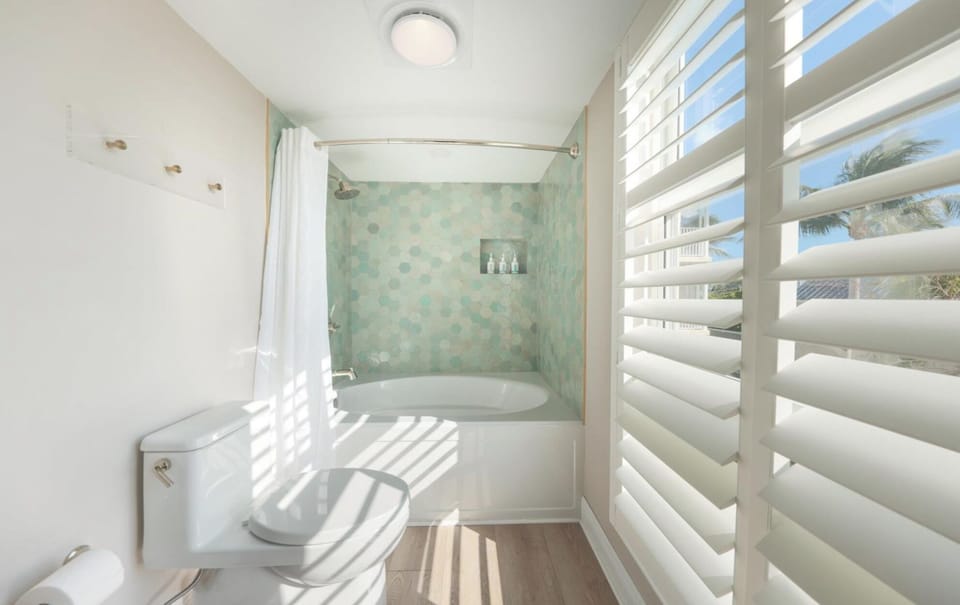 Refresh in a sunlit bath with a deep soaking tub.