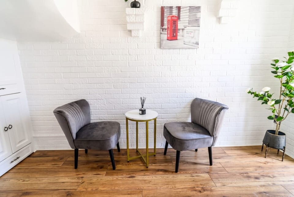 Quiet reading nook with feature brick wall and boutique touches