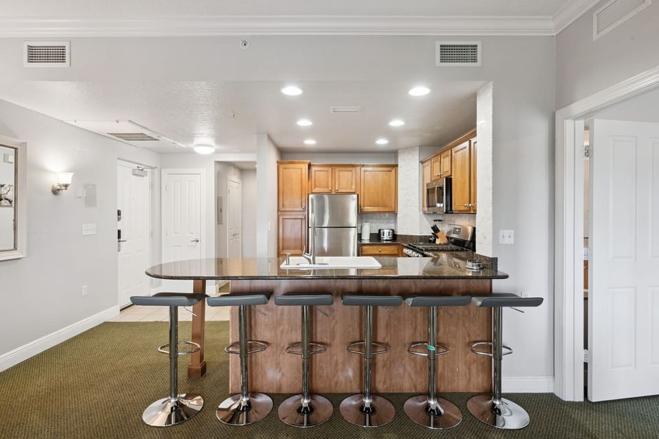 Gather around the oversized breakfast bar for morning coffee, quick lunches, or late-night conversations.