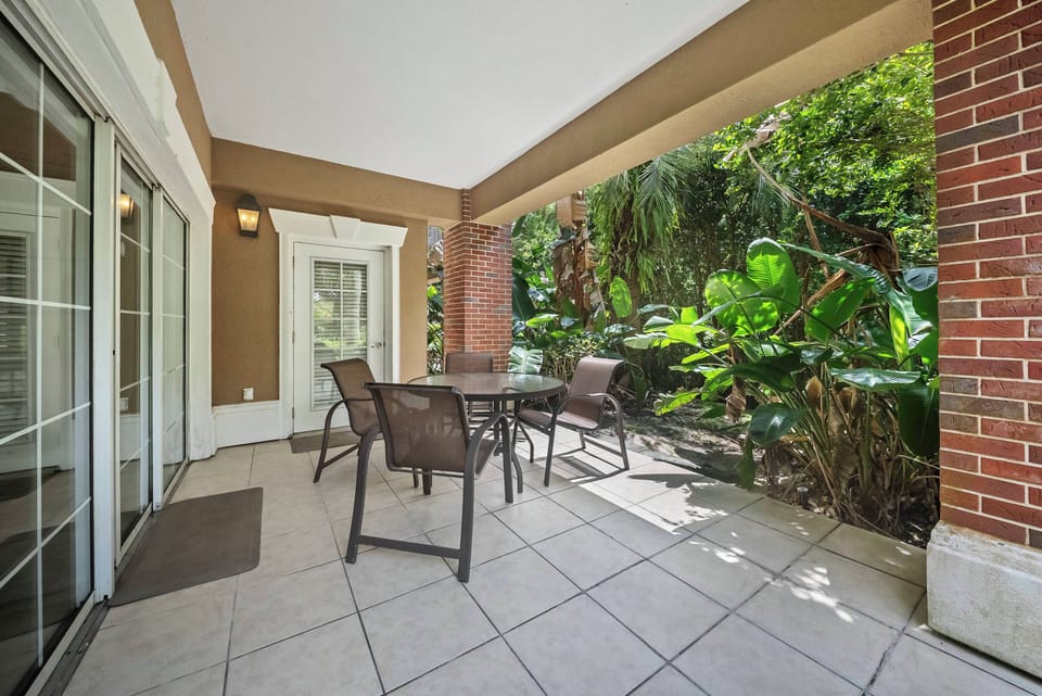 Enjoy the charming patio with a sleek glass table and comfy wicker chairs, ideal for morning coffee. Surrounded by lush greenery, it's a peaceful spot to relax and soak in the beauty of nature.
