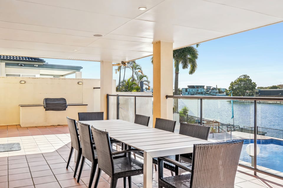 Fire up the gas BBQ and gather around the outdoor dining table for eight, with the covered patio setting the scene for alfresco meals beside the pool and canal.