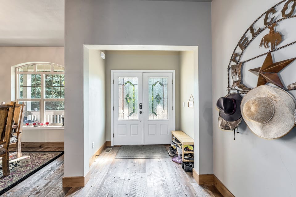 Step inside to find a welcoming entryway with charming stained-glass doors and light wood floors that flow through the home, setting a warm and inviting tone for your stay.