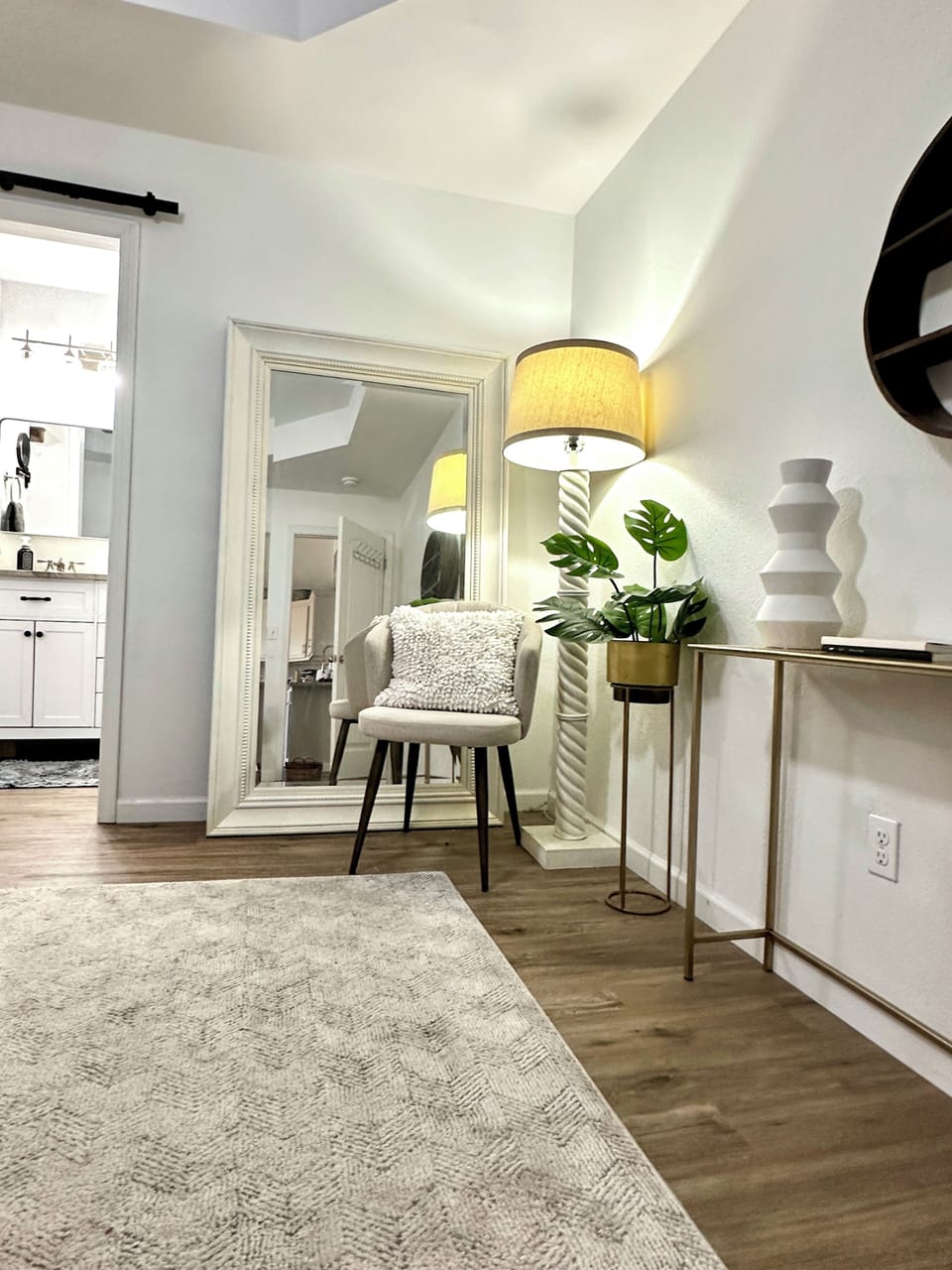 Cozy sitting area with a full-length mirror and chair for getting ready.