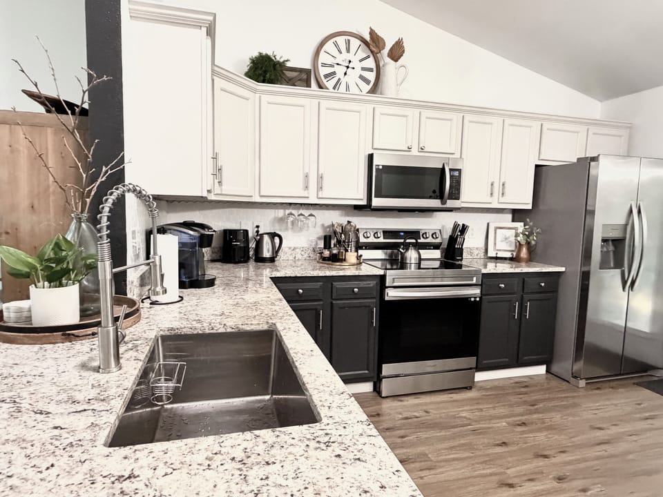 Spacious countertop with deep sink and plenty of room for meal preparation.