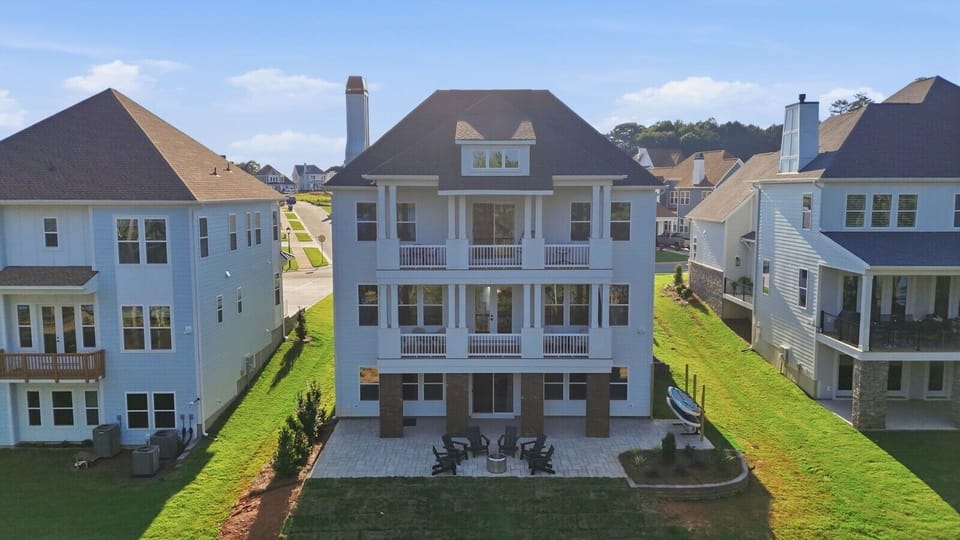 Lake-facing home with multiple covered balconies and outdoor spaces to relax and enjoy the view