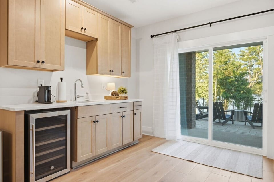 Convenient lower-level kitchenette with coffee station, mini fridge, and direct access to the patio and fire pit