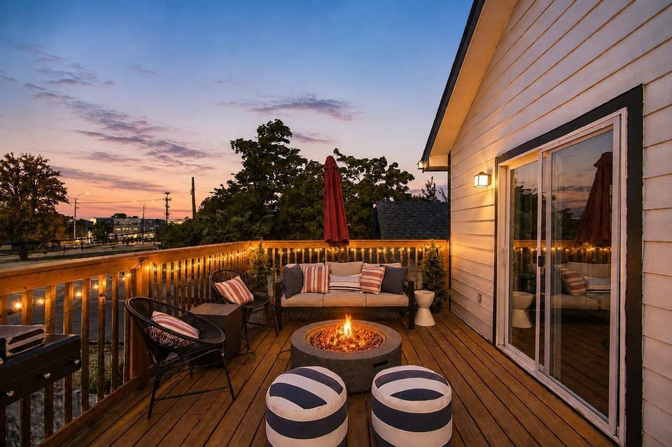 String lights, a crackling fire pit, and skyline views — this rooftop deck is where your evenings slow all the way down.