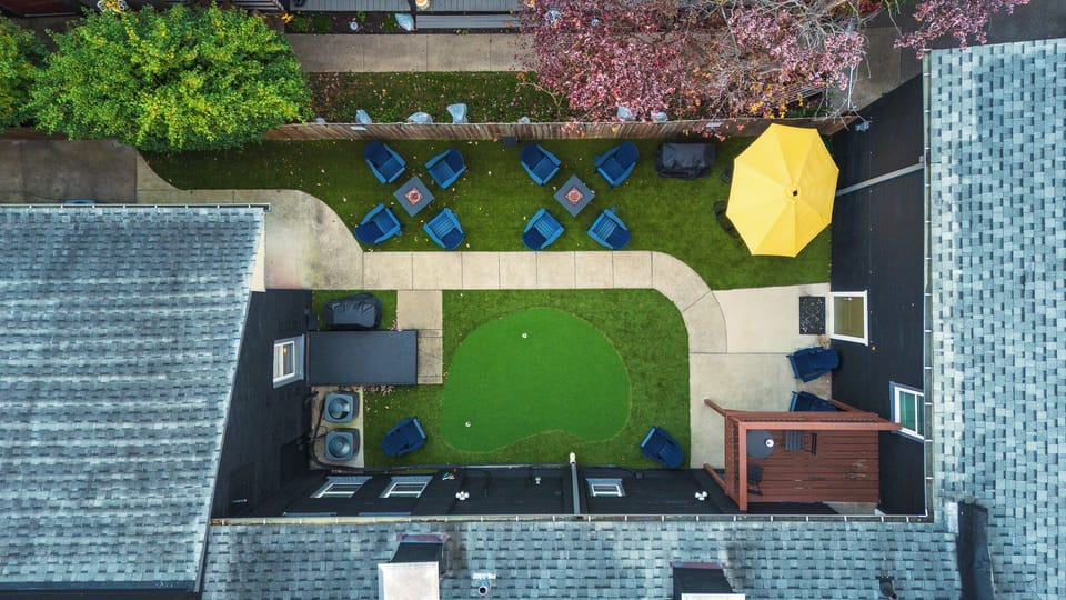 Private backyard with putting green, fire pits, and stylish lounge seating