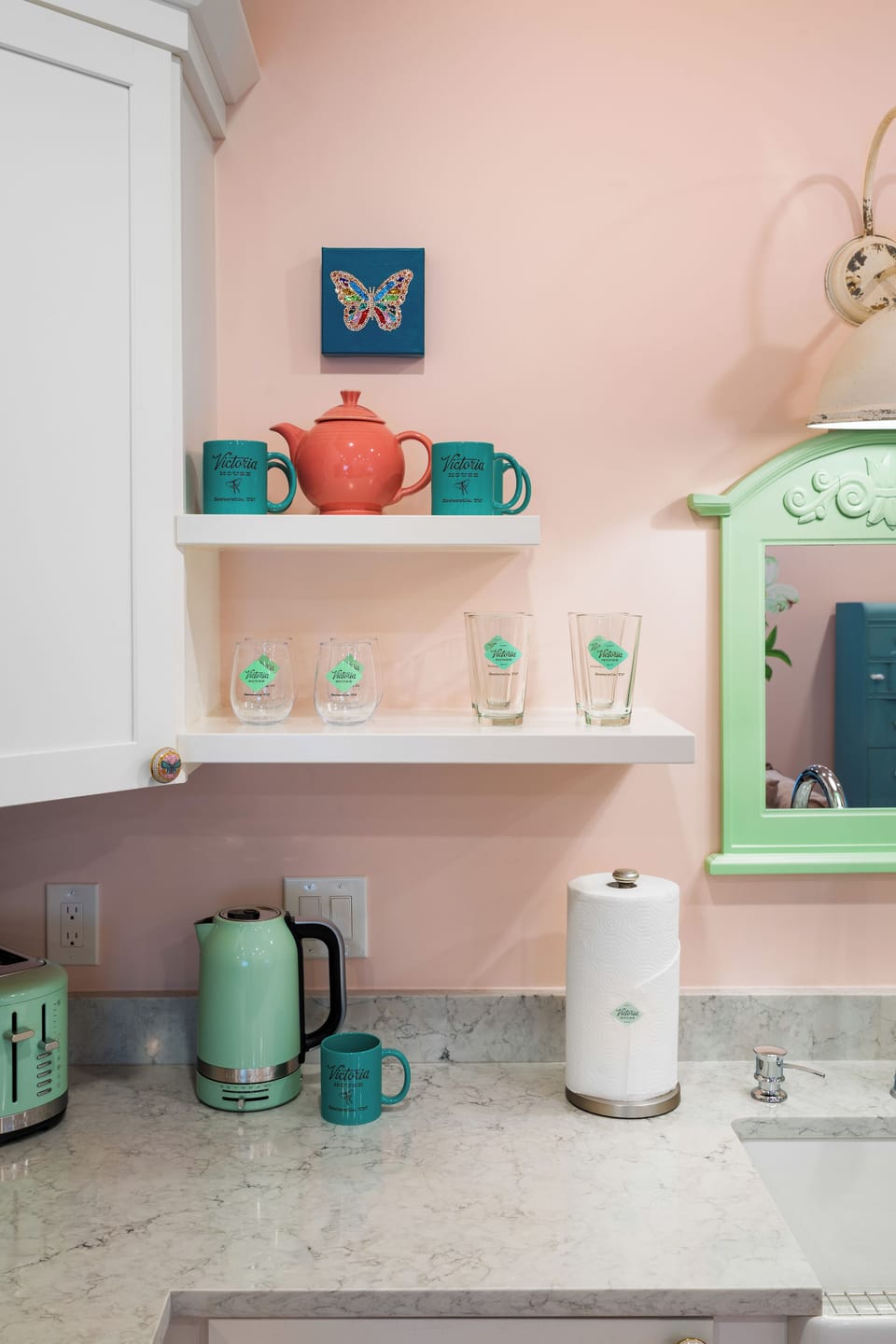Charming pastel coffee nook with open shelving and stylish mint accents