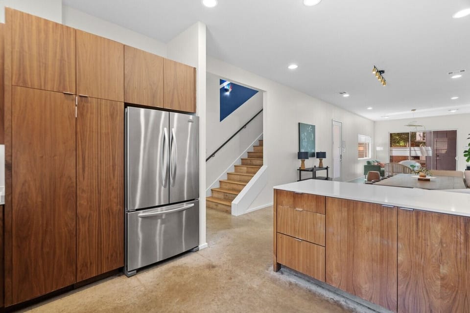 Keep everyone stocked with the French-door refrigerator and tall pantry cabinets in this walnut kitchen.