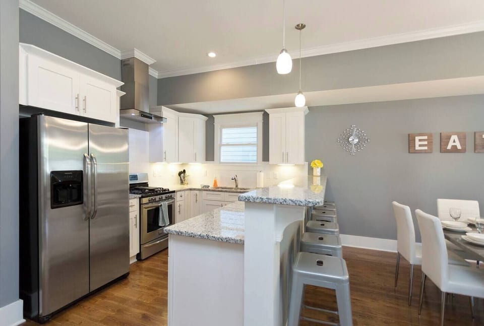 The kitchen with bar stools.