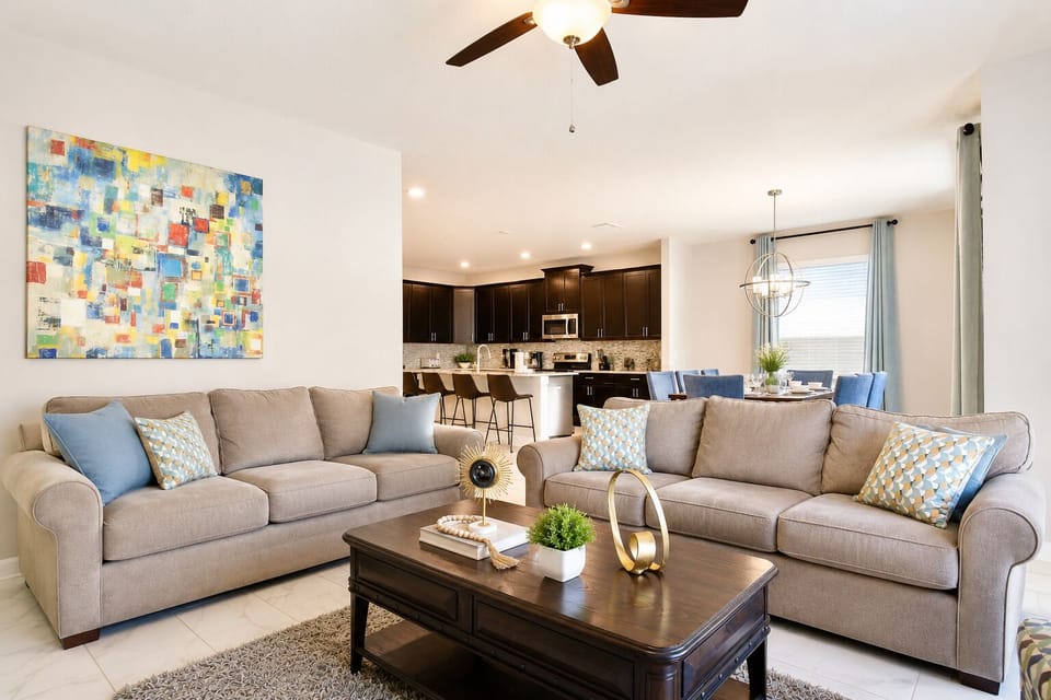 Bright open-concept living room with stylish kitchen, dining, and cozy seating
