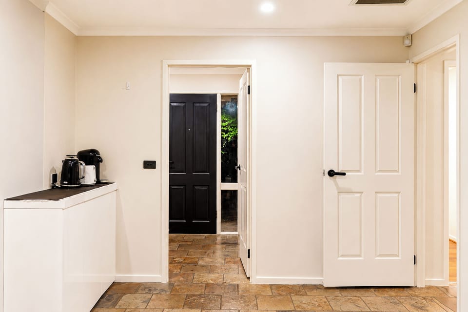 Bright entryway with tiled floors and a handy coffee station