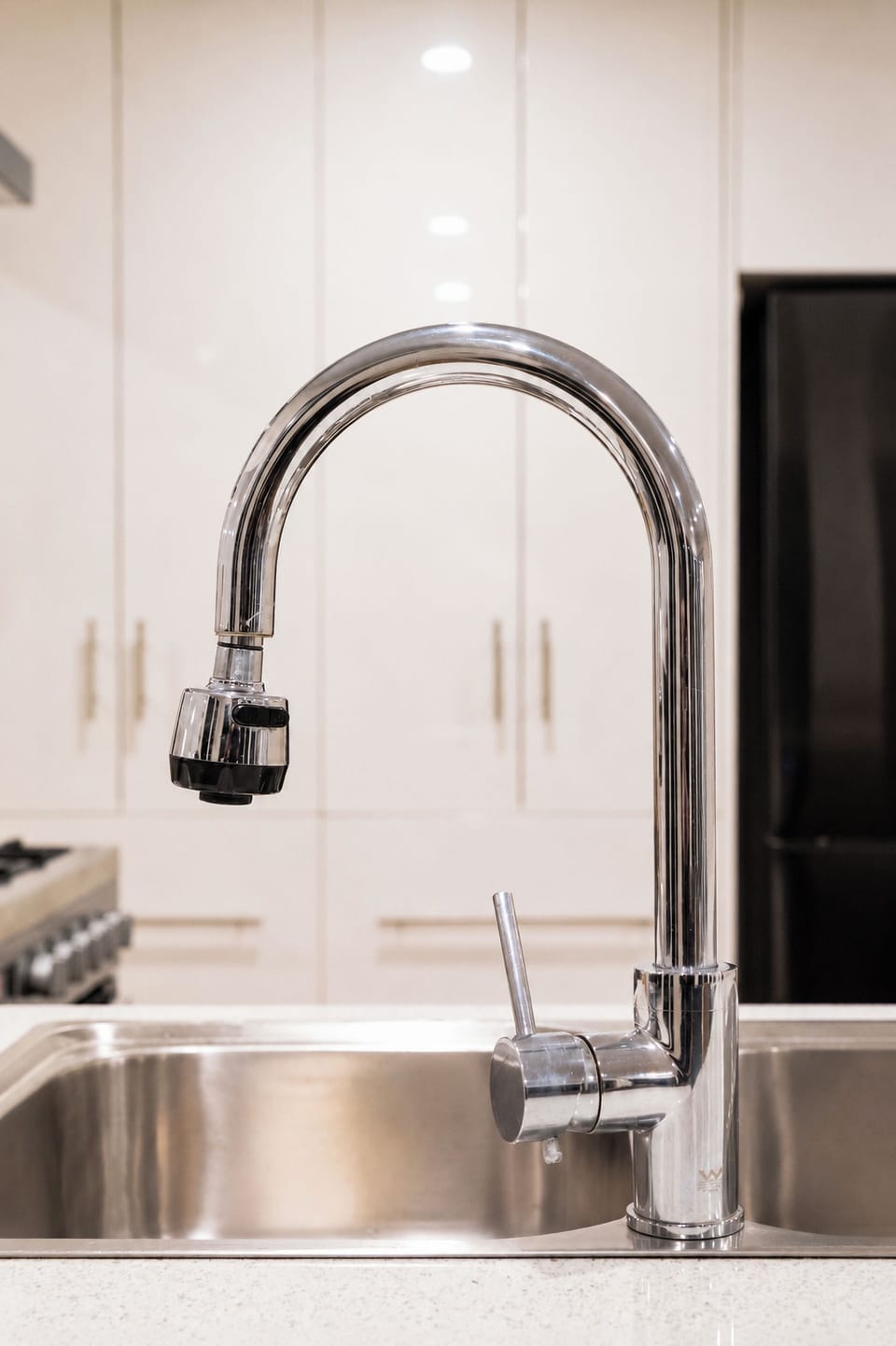 Modern kitchen with sleek chrome faucet and bright, clean finishes