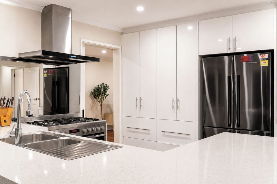 Bright modern kitchen with large island, gas cooktop, and ample storage