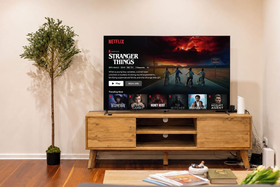 Cozy living area with large smart TV and stylish wooden media console