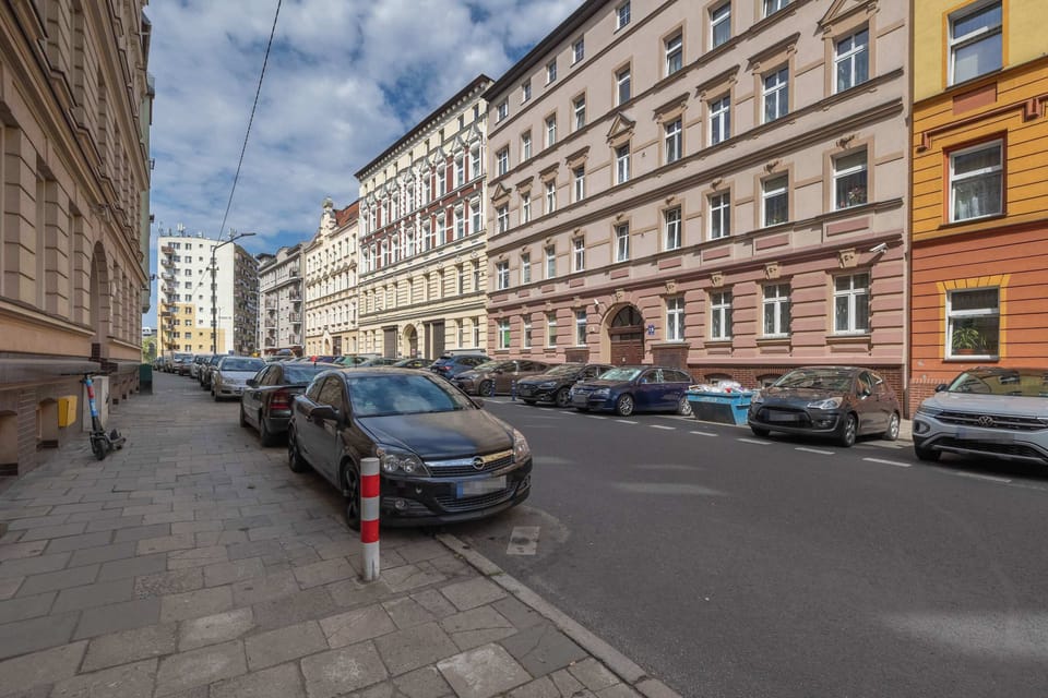 A street view showing the apartment building and neighboring historic buildings