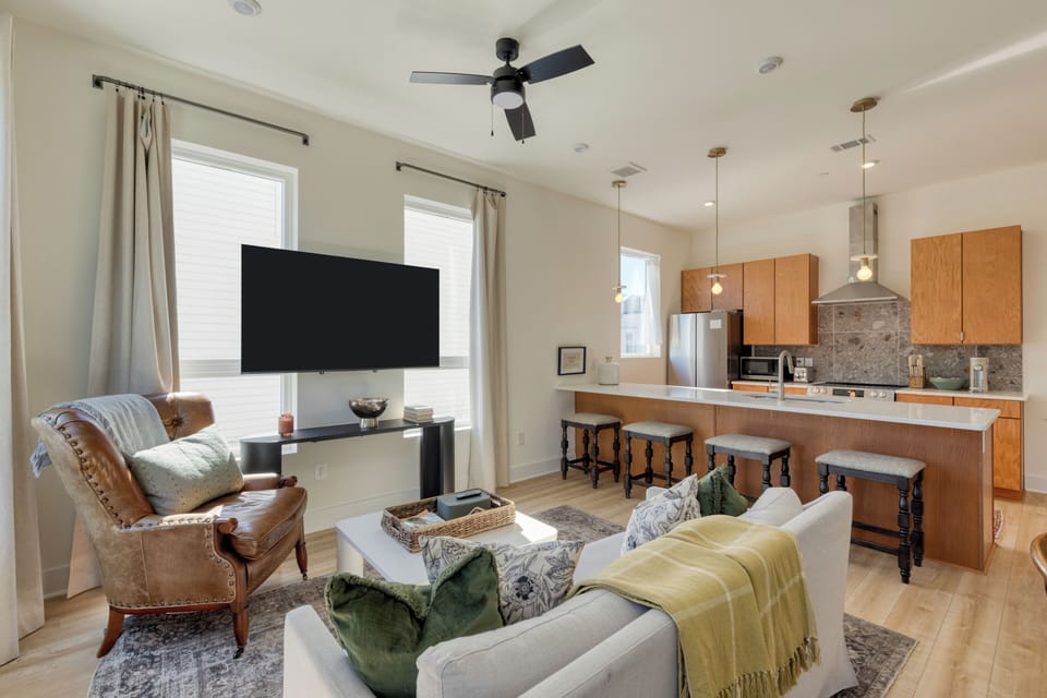 The living room features a large window and a chic modern design. (Hearth and Hideout)