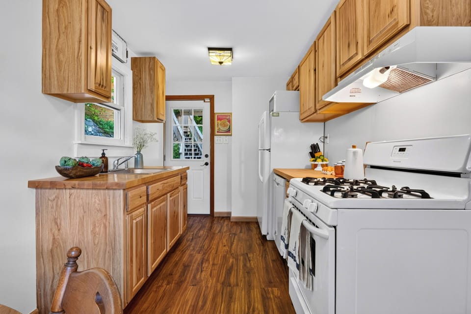 Bright kitchen with warm wood cabinetry, full appliances, and a cozy breakfast nook.