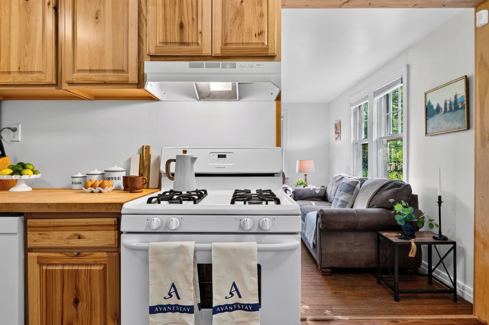 Bright kitchen with warm wood cabinetry, full appliances, and a cozy breakfast nook.