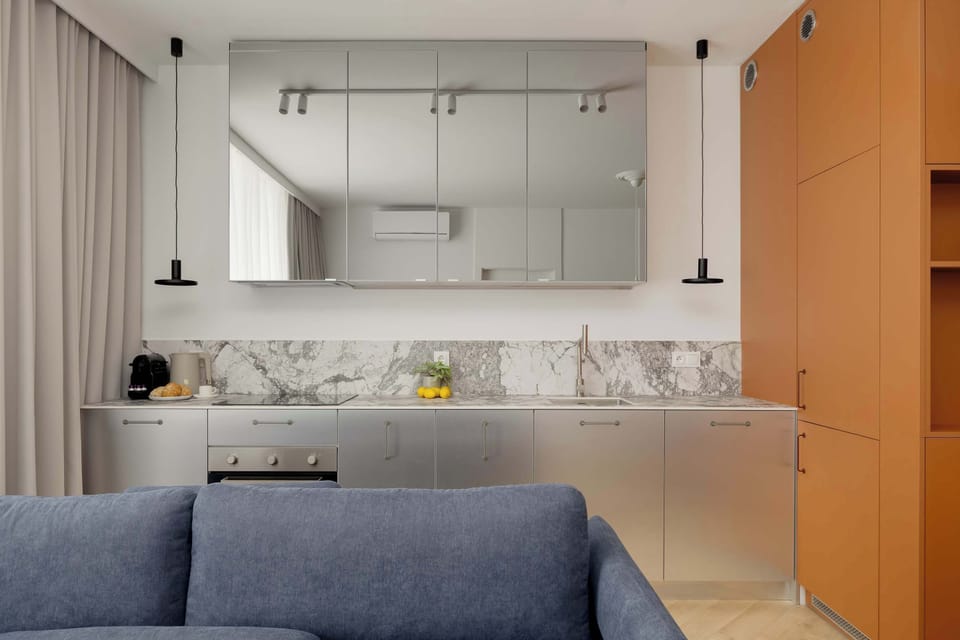 The sleek design of the kitchenette blending seamlessly with the living area.