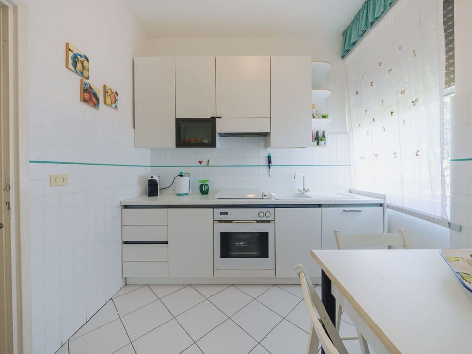 Kitchen, Kitchen Appliance, Countertop, Flooring, Major Appliance, Interior Design, Cabinetry, Furniture, Floor, Lighting