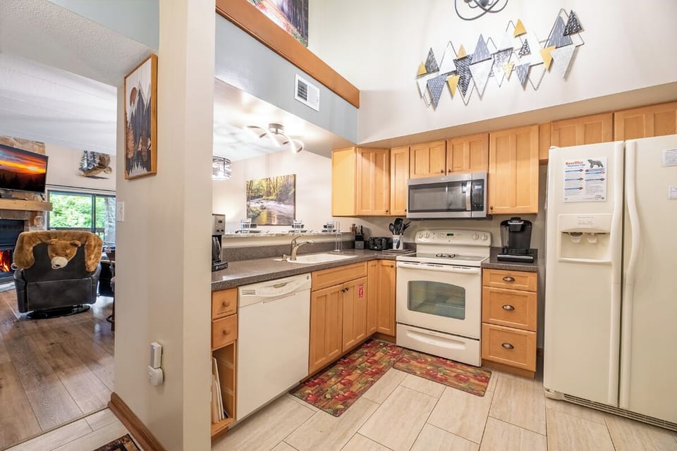 Your fully equipped kitchen awaits with granite counters, modern appliances, and everything you need to prepare meals during your stay. Bright, functional, and ready for your mountain getaway.