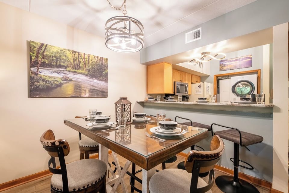 Gather around the handcrafted wooden table for memorable meals together. The open kitchen makes cooking and conversation effortless, with thoughtful details and warm lighting creating an inviting space for your stay.