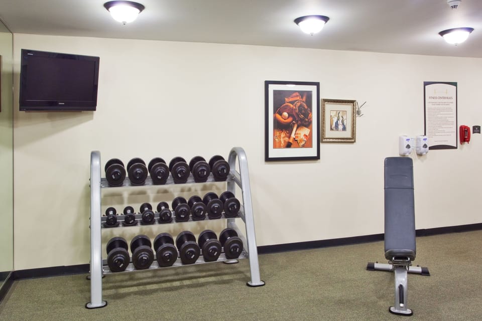 Lift your spirits in a well-equipped gym, complete with dumbbells and a bench for strength training.