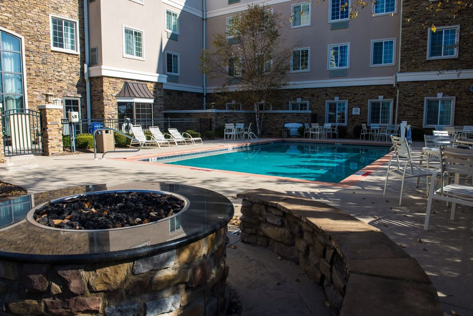Gather around the outdoor stone fire pit, perfect for cozy evenings by the pool.