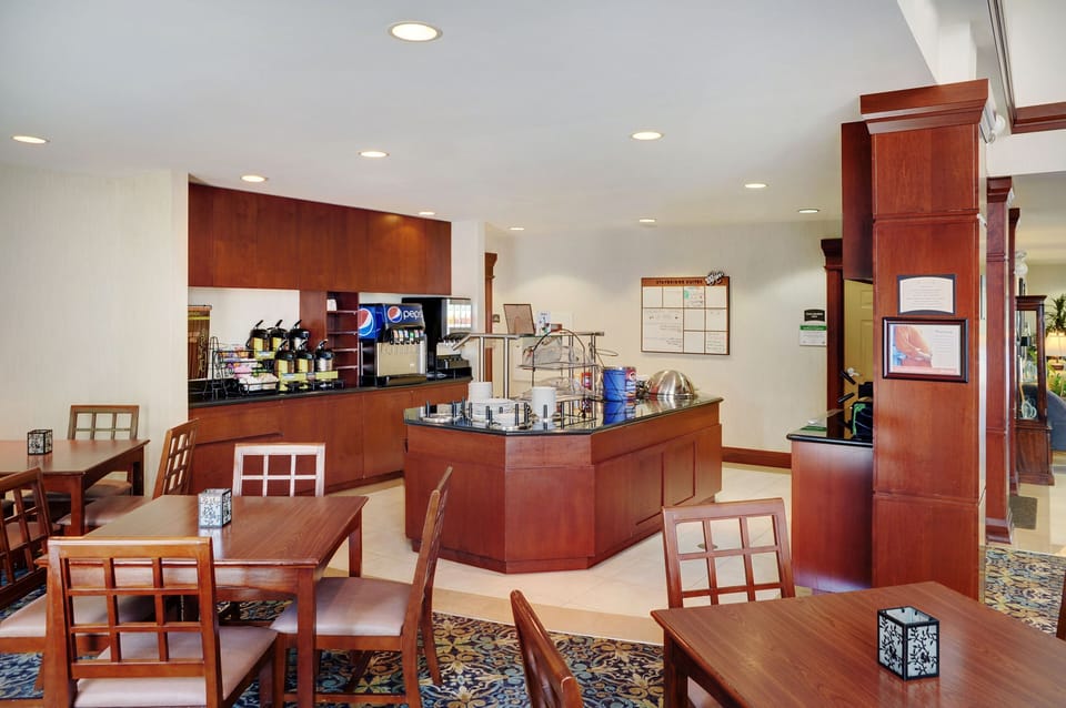 Breakfast station with hot and cold food options for guests.