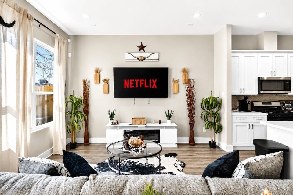 Living Room: Bright yellow walls and modern decor create a vibrant space for relaxation and fun!